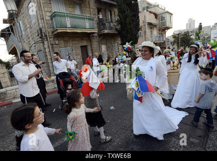 Israelis wave Pro-Israel Christen aus den Philippinen, wie sie in der jährlichen Jerusalem Parade während der Sukkot Urlaub, oder Fest der Tablernacles, im Zentrum von Jerusalem, Israel, 4. Oktober 2012. Mehr als 5.000 Christen aus über 100 Ländern strömten nach Jerusalem, am Fest der Laubhütten Urlaub ihre Unterstützung für Israel und das jüdische Volk, an einer Veranstaltung der Internationalen Christlichen Botschaft in Jerusalem gefördert zu zeigen. UPI/Debbie Hill Stockfoto