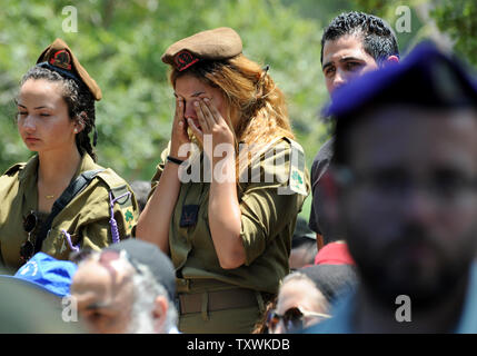 Israelische Soldaten weinen an der Beerdigung von großen tsafrir Baror, 32, im Holon Friedhof, Israel, 21. Juli 2014. Baror, ein Offizier der Golan Brigade, wurde von palästinensischen Extremisten im Gazastreifen getötet. Er hinterlässt eine Ehefrau, Sivon, die acht Monate schwanger ist und ein Jahr alten Tochter. Die Israel Defence Force sagt, es hat 18 Soldaten verloren, während mehr als 508 Palästinenser in den 14 Tag Schlacht getötet worden sind. UPI/Debbie Hill Stockfoto