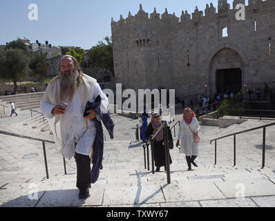 Eine ultra-orthodoxe Juden Wanderungen vor der muslimischen Frauen, die außerhalb der Damaskus Tor in der Altstadt von Jerusalem, an Rosch Haschanah, das Jüdische Neue Jahr, und das Islamische Neujahr, 21. September 2017. Beide Religionen folgen dem Mondkalender. Foto von Debbie Hill/UPI Stockfoto