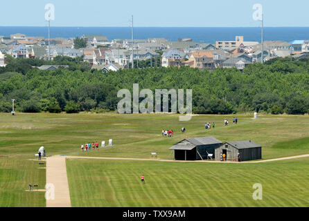 Der Atlantik ist die Kulisse für den National Park Service Wright Brothers National Memorial in Kill Devil Hills in der Nähe von Kitty Hawk auf den Outer Banks von North Carolina am 25. Juli 2015. Orville und Wilbur Wright haben Ihr segelflugzeug Tests von 1900 und flog ersten Flugzeug der Welt an diesem langen Sandstrand am 17. Dezember 1903. Repliken der Brüder Wohn- und Flugzeug Aufhängung auf der rechten Seite Mit dem Flugzeug take-off Punkt Denkmal auf der linken Seite gesehen werden kann. Der erste Flug reisten 120 Fuß und dauerte 12 Sekunden. Foto von Pat Benic/UPI Stockfoto