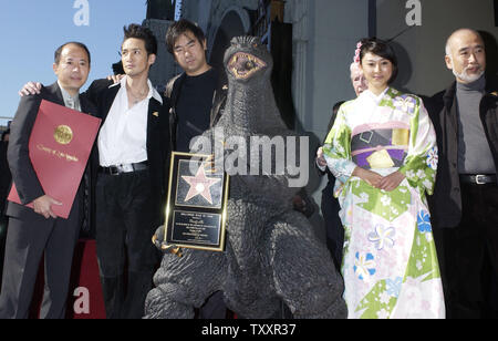 Film 'Godzilla' hält eine Replik Plakette während mit japanischen Schauspielern und Regisseuren während einer Zeremonie ein Stern auf dem Hollywood Walk of Fame erhalten posiert in Hollywood, Kalifornien, 29. November 2004. Von links sind Hersteller Shogo Tomiyama, Schauspieler Masahiro Matsuoka, Regisseur Ryuhei Kitamura, Godzilla, Schauspielerin Rei Kiku Kawa und Special Effects director Eiichi Asada. Der Film Symbol feiert sein 50-jähriges Bestehen mit dem Stern als auch die Premiere des Films "Godzilla Final Wars" später am Tag. (UPI Foto/Jim Ruymen) Stockfoto