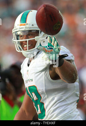 Miami Dolphins RB Marcus Thigpen Lächeln nach einem 14 Yard Touchdown gegen die New England Patriots im 4. Quartal bei Sun Life Stadium in Miami, Florida, am 15. Dezember, 2013. Die Delphine besiegt die Patrioten 24-20. UPI/Susan Knowles Stockfoto