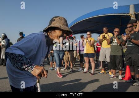 Eiko, Kadena Special Olympics Athlet, erhält Grüße und Prost von Freiwilligen während der Athlet Anreise Veranstaltung Nov. 5, 2016, bei Kadena Air Base, Japan. Rund 1.000 amerikanische Freiwillige mit mehr als 500 lokalen Dolmetscher gepaart KSO Athleten, die von sechs bis 95 Jahren reichten zu unterstützen. Stockfoto