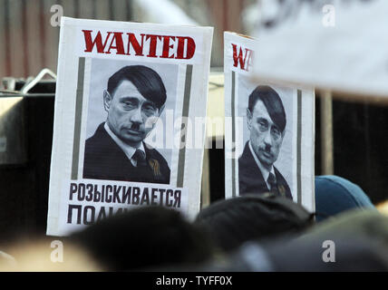 Bilder gegen den russischen Premierminister Wladimir Putin werden während einer Kundgebung der Opposition in Moskau, am 4. Februar 2012 gesehen. Trotz der kalten Temperaturen pro-Regierung und regierungsfeindlichen Demonstranten kam heraus zu protestieren und die derzeitige Regierung unterstützen. UPI Stockfoto