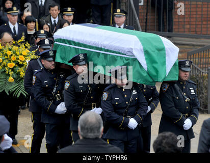 Der Sarg mit den sterblichen Überresten von New York Polizeioffizier Wenjian Liu ist aus Aievoli Begräbnis- Haus in New York City am 4. Januar 2015 durchgeführt. Officer Rafael Ramos zusammen mit Officer Wenjian Liu wurden vor zwei Wochen erschossen, als sie in ihren korrigierten Streifenwagen an der Ecke von Myrtle Avenue und Tompkins Avenue in Bedford-Stuyvesant, Brooklyn saß. Foto von Dennis Van Tine/UPI Stockfoto