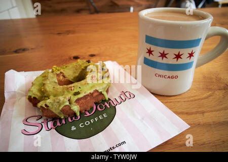 Becher Kaffee und lemon Pistazie altmodische Spezialität traditionelle Donut in Stans Donuts in Chicago, IL USA Stockfoto