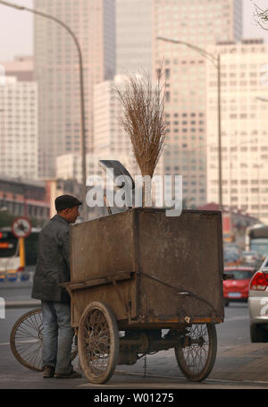 Mit niedrigem Einkommen der chinesischen Kehrmaschinen und Müllsammler Fahrrad fahren, wie Sie die Straßen von Downtown Beijing patrouille am 9. November 2012. Der chinesische Präsident Hu Jintao, in der Bereitstellung der Arbeitsgruppe Bericht zum 18. Kongress der Kommunistischen Partei, warnte die zukünftigen Führer des Landes, dass eine immer grösser werdende Einkommensschere im ganzen Land ist die Schaffung sozialer Instabilität. China wird in Kürze neue Führer, viele, die Millionäre sind, während Millionen von Chinesen noch auf $ 1 pro Tag leben. UPI/Stephen Rasierer Stockfoto