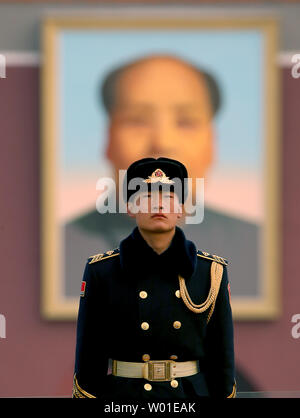 Ein chinesischer Soldat steht Wache auf dem Platz des Himmlischen Friedens vor einem riesigen Portrait des ehemaligen Steuermann Mao Zedong die jährlichen Nationalen Volkskongresses in Peking am 5. März 2018 geöffnet. Chinas weitgehend zeremoniellen Parlament Montag geöffnet, mit über 3.000 Teilnehmer balanciert, kontroverse Maßnahmen, die es der chinesische Präsident Xi Jinping auf unbegrenzte Zeit zu unterstützen. Foto von Stephen Rasierer/UPI Stockfoto