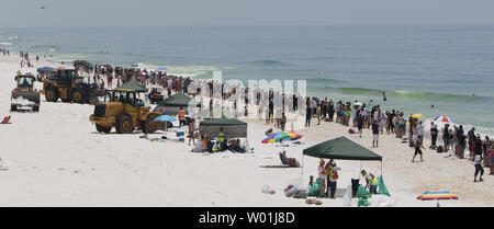 BP-clean-up-Crews machen Sie eine Pause, während mehrere hundert Menschen Pensacola Beach für die Hände über dem Sand Protest in Pensacola Beach, Florida am 26. Juni 2010. Hände über den Sand ist offshore Öl bohren zu protestieren. UPI/Mark Wallheiser Stockfoto