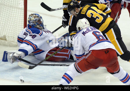 New York Rangers defenseman Dylan McIlrath (6) hält die Pittsburgh Penguins rechten Flügel Tom Kuhnhackl (34) weg von der pucks wie New York Rangers goalie Henrik Lundqvist (30) fällt vor dem Ziel in der dritten Periode des Rangers 4-2 in Spiel zwei der ersten Runde der Stanley Cup playoffs Gewinn an den Consol Energy Center in Pittsburgh am 16. April 2016. Foto von Archie Tischler/UPI Stockfoto