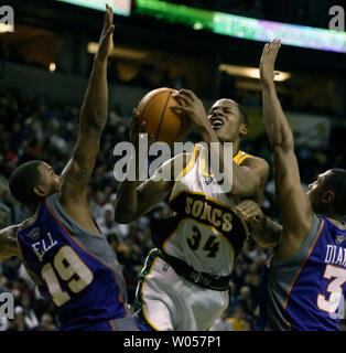 Seattle Supersonics" Ray Allen (54) ist verschmutzt, wie er in den Warenkorb zwischen Raja Phoenix Suns' Bell Antriebe, Links, und Boris Diaw, von Frankreich, in das vierte Quartal in der Key Arena in Seattle am 14. März 2006. (UPI Foto/Jim Bryant) Stockfoto