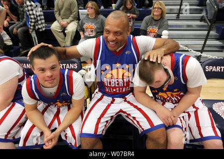 St. Louis Rams' Aeneas Williams, holds his son, Lazarus, as he