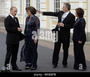 Der russische Präsident Wladimir Putin (L) spricht mit Cherie Blair (2. L) wie ihr Ehemann, der britische Premierminister Tony Blair spricht mit ersten Russischen Frau Ljudmila Putina (R) vor ein Abendessen für die G8-Führer vor dem Schloss Peterhof in St. Petersburg, Russland, am 15. Juli 2006. (UPI Foto/Anatoli Zhdanov) Stockfoto