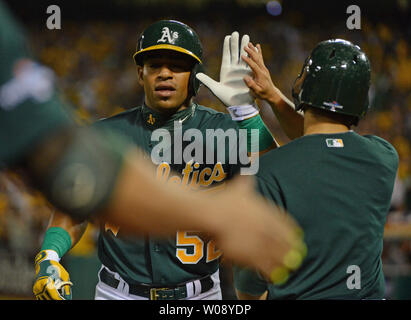 Oakland A's Yoenis Cespedes (52) schlägt die Hände Mannschaftskameraden, nachdem er einen 2 run Home Run aus Detroit Tiger Max Scherzer im siebten Inning von Spiel 1 der American League Division Series an O. co Coliseum in Oakland, Kalifornien am 4. Oktober 2013. UPI/Terry Schmitt Stockfoto