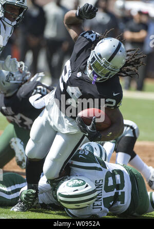 Oakland Raiders RB Marshawn Lynch (24) durch New York Jets Jordanien Jenkins (48) Im zweiten Quartal am Kolosseum in Oakland, Kalifornien am 17. September 2017 ergriff. Die Räuber besiegt die Jets45-20. Foto von Terry Schmitt/UPI Stockfoto