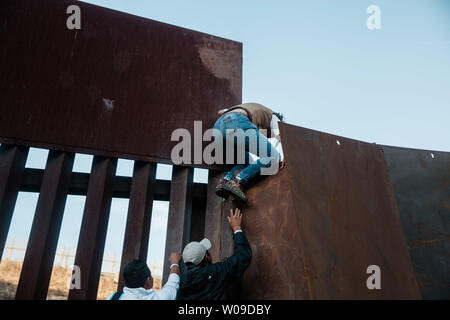 Mit wachsender Frustration an die Dauer der Asylverfahren, Migrantinnen und Migranten über den Grenzzaun, teilt den Vereinigten Staaten und Mexiko am 2. Dezember 2018 in der Nähe von Las Playas de Tijuana, Mexiko. Foto von Ariana Drehsler/UPI Stockfoto