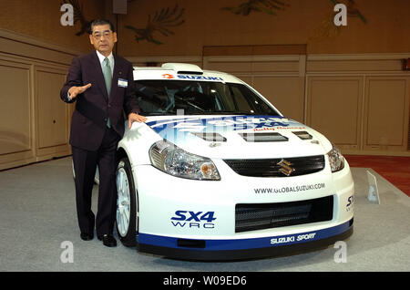 Hiroshi Tsuda, Präsident der Suzuki Motor Corporation, steht mit der SX4 WRC Prototyp auf einer Pressekonferenz in Tokio, Japan, am 4. Juli 2006. Der X4 WRC" in die "World Rally Championship" im Sommer 2007 ein. (UPI Foto/Keizo Mori) Stockfoto