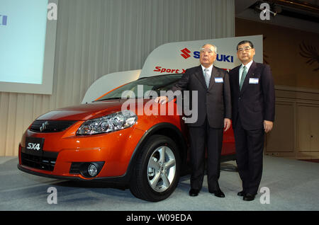 Hiroshi Tsuda, Präsident der Suzuki Motor Corporation. und Osamu Suzuki, Chairman und CEO von Suzuki Motor Corporation., stand mit dem X4 1.5XG" während einer Pressekonferenz in Tokio, Japan, am 4. Juli 2006. (UPI Foto/Keizo Mori) Stockfoto