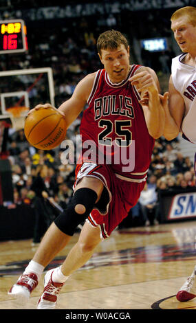 Chicago Bulls Darius Songaila treibt die Kugel hinter Toronto Raptors' Matt Bonner im zweiten Quartal Maßnahmen auf das Air Canada Centre am 14. Dezember in Toronto, Kanada 2005. Die Bullen besiegten die Raptors 105-94. Songaila zählte 18 Punkte auf der Nacht der Stiere zu einem 105-94 über die Raptors zu führen. (UPI Foto/Christine Kauen) Stockfoto