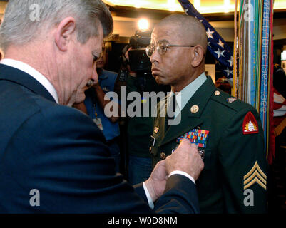 Sekretär des Veterans Affairs James Nicholson (L) Auszeichnungen der militärischen Ordnung des Purple Heart zu Sgt. Tyrone Carelock, von Washington DC, für Wunden gelitten, während im Irak, während einer Zeremonie in Washington am 1. November 2006. Die drei anderen irakischen Veteranen empfangen die Purple Heart einschließlich Sgt. Jeffrey Combs, USMC 2. Tank Battalion, 2nd Marine Division, von White Plains, N.Y.; Pvt. Kevin Araujo, 10 Mountain Division, von Houston, TX; und SPC. Nicholas Helfferich, 2nd Battalion, 37th Armor, 1st Armored Division, von Latrobe, PA. (UPI Foto/Kevin Dietsch) Stockfoto