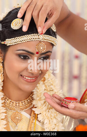 Indische paar Durchführung Sindoor Daan Zeremonie in malayalee Hochzeit Stockfoto