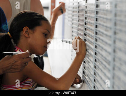 Die Menschen ihre Namen und Notizen auf einem 9/11 Tribut Stahlträger außerhalb das Newseum in Washington am 3. Juli 2009 zu unterzeichnen. Der Strahl wird in der Konstruktion der nationalen September 11 Memorial und Museum in New York City verwendet werden. (UPI Foto/Alexis C Glenn) Stockfoto