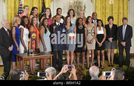 US-Präsident Barack Obama hält eine Jacke präsentiert von der UConn 2013 basketball Champions der NCAA Frauen wie er sie begrüßt zum Weißen Haus, Juli 31, 2013, in Washington, DC. Obama setzte sich die Tradition der Einladende "Sports Champions" zum Weißen Haus und dankte ihnen für ihren Dienst an der Gemeinschaft. UPI/Mike Theiler Stockfoto