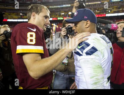 Washington Redskins quarterback Kirk Cousins (8) spricht zu Seattle Seahawks Quarterback Russell Wilson nach der Seahawks entfettet die Redskins 27-17 am FedEx Feld in Landover, Maryland am 6. Oktober 2014. UPI/Kevin Dietsch Stockfoto