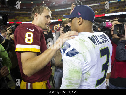 Washington Redskins quarterback Kirk Cousins (8) spricht zu Seattle Seahawks Quarterback Russell Wilson nach der Seahawks entfettet die Redskins 27-17 am FedEx Feld in Landover, Maryland am 6. Oktober 2014. UPI/Kevin Dietsch Stockfoto
