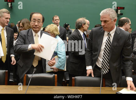 Takata Corporation Senior VP für globale Qualitätssicherung Hiroshi Shimizu (L), sammelt seine Papiere, wie Er und Honda Nordamerika Executive VP Rick Schostek ihr Zeugnis vor dem Haus Energie und Handel Ausschuss für Takata airbag Brüche und erinnert daran, auf dem Capitol Hill, 3. Dezember 2014, in Washington, DC. Eine Reihe von Airbags, die bereitgestellt haben tödliche Geschosse in den Auto Passagiere gesendet. UPI/Mike Theiler Stockfoto