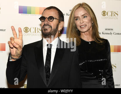 Ehemalige Beatle Ringo Starr gibt das Friedenszeichen zu Fotografen wie kommt er mit seiner Frau Barbara Bach für die 2016 Kennedy Center Honors Gala im Kennedy Center, Dezember 4, 2016, in Washington, DC. Die Ehrungen werden jährlich auf fünf Künstler für ihr Lebenswerk in der Kunst und Kultur verliehen. Foto von Mike Theiler/UPI Stockfoto