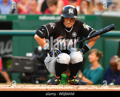 Miami Marlins' Ichiro Suzuki, right, poses for a photo with Seattle Mariners  pitcher Hisashi Iwakuma, left, and Mariners translator Antony Suzuki,  center, before batting practice prior to a baseball game against Ichiro's