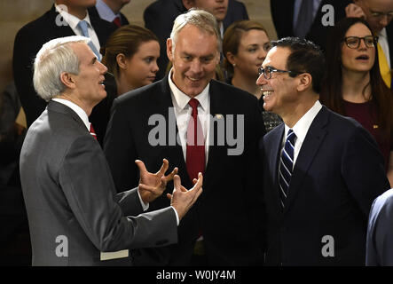 (L - R) Sen. Rob Portman von Ohio, Innenraum Staatssekretär Ryan Zinke und Treasury Secretary Steven Mnuchin Chat als sie den Beginn einer Zeremonie der späten Pfr. Billy Graham, in dem US Capitol Rotunde, Februar 28, 2018, in Washington, DC zu Ehren erwarten. Der Täufer Evangelist, 99, war ein informelles Berater des Präsidenten seit Präsident Harry Truman und ist die erste religiöse Führer zu Ehren im Capitol zu legen. Foto von Mike Theiler/UPI Stockfoto