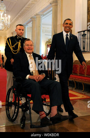 In dieser Datei Foto, US-Präsident Barack Obama geht mit ehemaliger Präsident George H.W. Bush im Osten Zimmer des Weißen Hauses zu den 5.000 th Award von Bushs 'Points of Light Foundation in Washington, DC am 15. Juli 2013 vorlegen. Bush hat die nationale Bewegung volunteerism und Dienst an der Gemeinschaft zu Vorauszahlung vor 20 Jahren, als er die 41. Präsident war. George Herbert Walker Bush starb am 30. November 2018 im Alter von 94 Jahren. UPI/Pat Benic Stockfoto