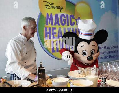 Chief Gary Jones und die Walt Disney Comicfigur Mickey Mouse ein gesundes Essen zubereiten, bevor die Ankündigung der Firma der erheblichen Weiterentwicklung bestehender Ernährung Leitlinien der Politik in Washington am 5. Juni 2012. UPI/Yuri Gripas. Stockfoto