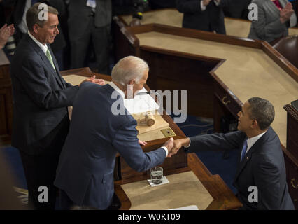 Us-Präsident Barack Obama schüttelt Hände mit US-Vizepräsident und Präsident des Senats Joe Biden als Sprecher des Repräsentantenhauses John Boehner sieht auf wie der Präsident trifft seine Rede zur Lage der Union zu einer gemeinsamen Sitzung des Kongresses und dem amerikanischen Volk im Haus Kammer am Kapitol am 28 Januar, 2014 in Washington, DC. Obama schwor die Mittelschicht zu helfen. UPI/Pat Benic Stockfoto