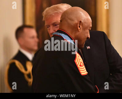 Präsident Donald Trump wispers zu Ehrenmedaille Empfänger pensionierte Sgt. Maj. John canley fafter den Preis im East Room des Weißen Hauses in Washington, DC am 17. Oktober 2018. Die 80-jährige ehemalige Marine, die in Oxnard, Kalifornien lebt, die Auszeichnung für Service erhalten in der Schlacht um Hue vor 50 Jahren. Foto von Pat Benic/UPI Stockfoto