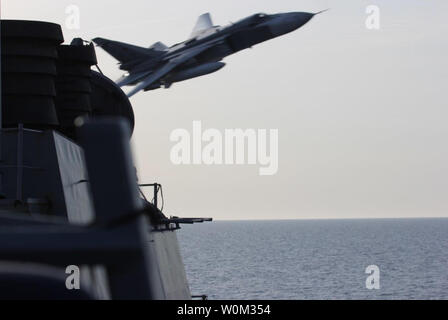 Eine russische Suchoi Su-24 Kampfflugzeug macht ein sehr niedriger Höhe Pass von der USS Donald Cook (DDG75) am 12. April 2016, bei Manövern in internationalen Gewässern in der Ostsee. Donald Cook, eine der Arleigh-Burke-Klasse geführte-missile Destroyer, vorwärts zu Rota, Spanien bereitgestellt werden, ist die Durchführung einer Routinepatrouille in den USA 6 Flotte Bereich der Maßnahmen zur Unterstützung der US-amerikanischen nationalen Sicherheitsinteressen in Europa. Foto: US Navy/UPI Stockfoto