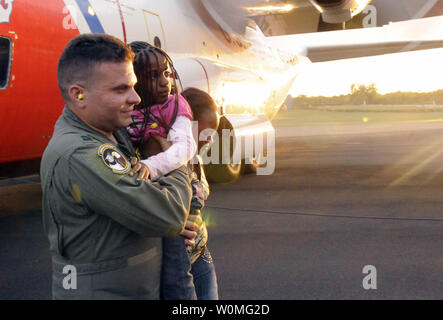 Kapitän Luis Martinez, von Puerto Rico Air National Guard, der U.S. Southern Command, trägt ein junges Mädchen, aus Haiti evakuiert nach einer 7.3 Erdbeben, durch Besatzungsmitglieder an Bord eines HC-130 Hercules-transportflugzeuge von Santo Domingo, Dominikanischen Republik am 14. Januar 2010. Coast Guard Besatzungen aus Clearwater, Florida sind in Zusammenarbeit mit mehreren Niederlassungen des US-Militärs, der US-Regierung, militärische Dienstleistungen aus der ganzen Welt und die Vereinten Nationen, auf der zweiten geraden Tag von Evakuierungen aus Port-au-Prince, Haiti. UPI/Mariana O'Leary/U.S. Küstenwache Stockfoto