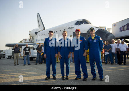 Die STS-135 Astronauten, von links und die Missionsspezialisten Rex Walheim, Sandy Magnus, Pilot Doug Hurley und Commander Chris Ferguson alle Stellen für Fotografen, kurz nachdem sie in den Space Shuttle Atlantis berührt am Kennedy Space Center der NASA Shuttle Landing Facility (SLF), den Abschluss seiner 13-tägigen Mission zur Internationalen Raumstation (ISS) und der letzte Flug des Space Shuttle Programms, frühen Donnerstag Morgen, 21. Juli 2011, in Cape Canaveral, Fla., Atlantis insgesamt 307 Tage im Weltraum verbracht und reiste fast 126 Millionen Meilen während seiner 33 Flüge. Atlantis, das vierte Orbiter bu Stockfoto