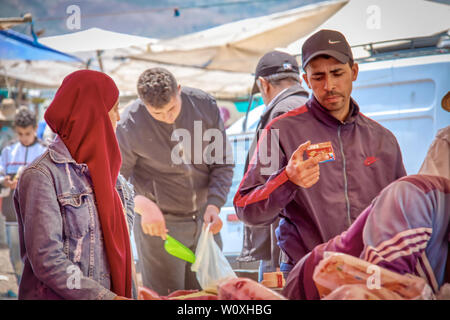 Oued Laou, Tetouan, Marokko - Mai 4, 2019: Kunden, die Produkte von einem der souk Stände auf der Suche Stockfoto