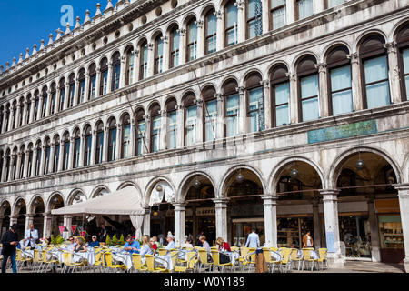 Venedig, Italien - April 2018: Restaurants und Touristen am berühmten Markusplatz von Venedig in einer schönen, sonnigen Frühling Tag Stockfoto