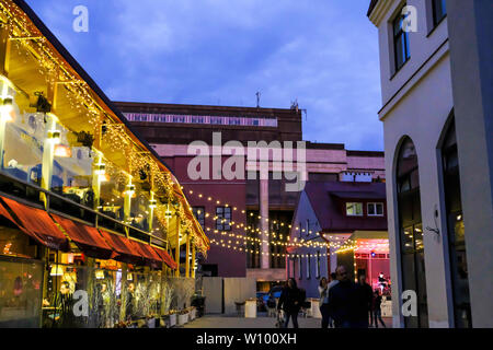Minsk, Weißrussland - 30. Juni 2018: Die Menschen gehen auf die Straße mit bunten Girlanden in Minsk Altstadt bei Nacht. Minsk, Weißrussland Stockfoto