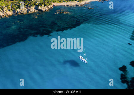 Ansicht von oben, atemberaubenden Blick auf einem Segelboot schwimmt auf einer wunderschönen türkisen Meer. Maddalena Archipelago National Park, Sardinien. Stockfoto