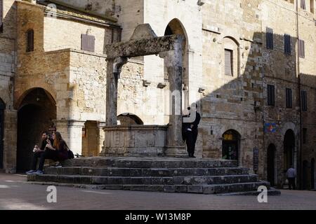San Gimignano, Italien - 03. März 2019: Touristen, die in der kleinen und charakteristischen Mittelalterlichen Stadt in der Toskana in der Nähe von Siena Stockfoto