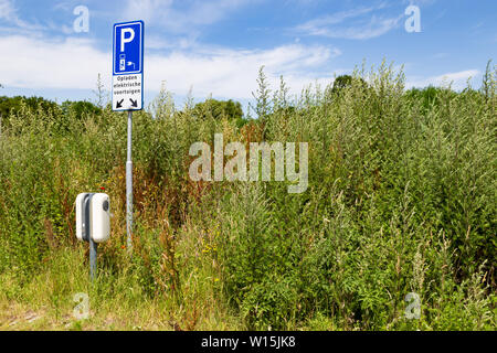 Elektrische Auto Batterie aufladen Station auf dem Parkplatz mitten in der Natur in den Niederlanden Stockfoto