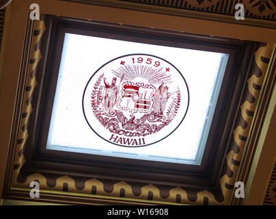 Lansing, Michigan, USA. 29 Juni, 2019. Nahaufnahme der Hawaii State Seal, einem der Glasscheiben in der Decke des Repräsentantenhauses Kammer im Inneren der Michigan State Capitol, das am 1. Januar eröffnet, 1879 in Lansing, Michigan am Samstag, 29. Juni 2018. Die Decke wurde entwickelt, bei Tageslicht zu lassen und hat ein Fenster mit dem Staat Dichtung für jeden der Staaten, die Vereinigten Staaten von Amerika umfassen, das Gebäude wurde von dem Architekten Elijah E. Myers entwickelt und ist einer der ersten State Capitols von einem erhabenen gusseiserne Kuppel, die auf der Kuppel des modelliert wurde aufgestockt werden Stockfoto