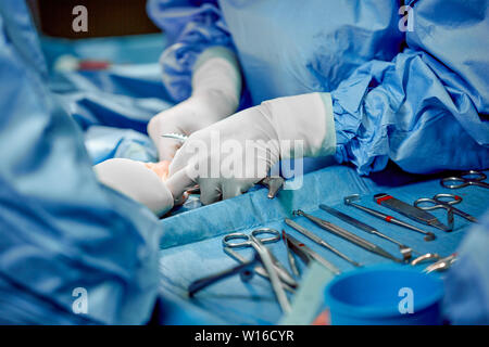 Chirurgische Instrumente und Instrumente, einschließlich skalpelle, Pinzetten und Zangen auf der Tabelle für Chirurgie. Medizin, Chirurgie, Leben zu retten. Stockfoto