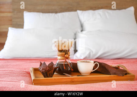 Fach mit leckeren Kaffee in chemex und Schale am Bett Stockfoto