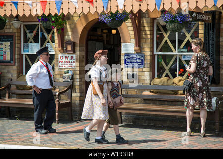 Kidderminster, Großbritannien. Juni 2019. Severn Valley Railways "die Rückkehr in die 1940er Jahre" beginnt dieses Wochenende mit einem fabelhaften Start in die Zeit der kostümierten Reenactors, die eine authentische Nachbildung des Britanniens im Zweiten Weltkrieg bieten. Zwei evakuierte Kinder sind hier an einem alten, ländlichen Bahnhof warten auf die Abholung durch ihre Gastfamilien. Bild: Lee Hudson Stockfoto